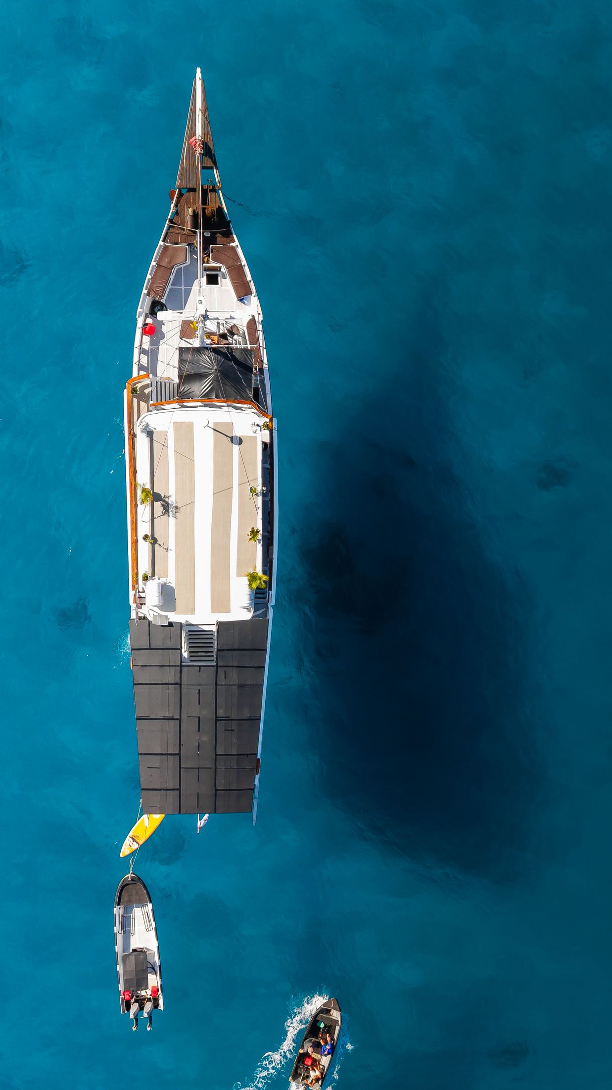 Top-down drone view of Maki at anchor