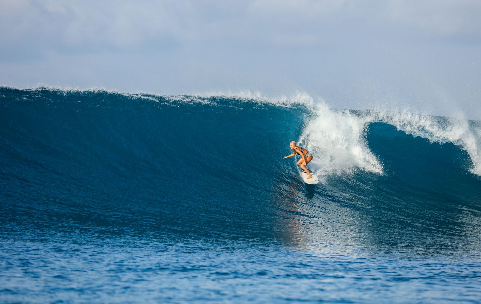 Surfer riding a big blue wave